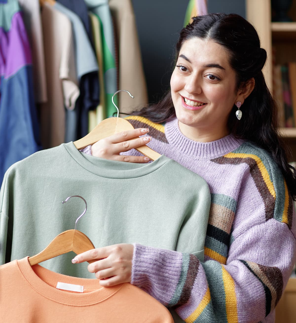 Seller displaying vintage clothing items for an estate sale